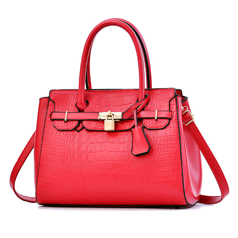 Red handbag with gold accents on a white background