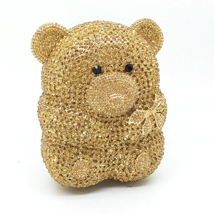 golden teddy bear-shaped  cyrstal clutch bag with crystal embellishments on a white background