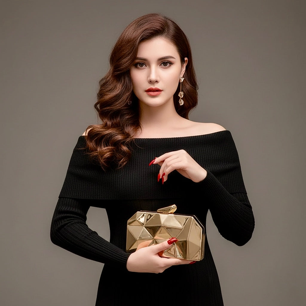 Model holding the Baazuu Prism Aura acrylic clutch in gold. The modern box clutch features a 3D faceted design, perfect as a statement evening bag.